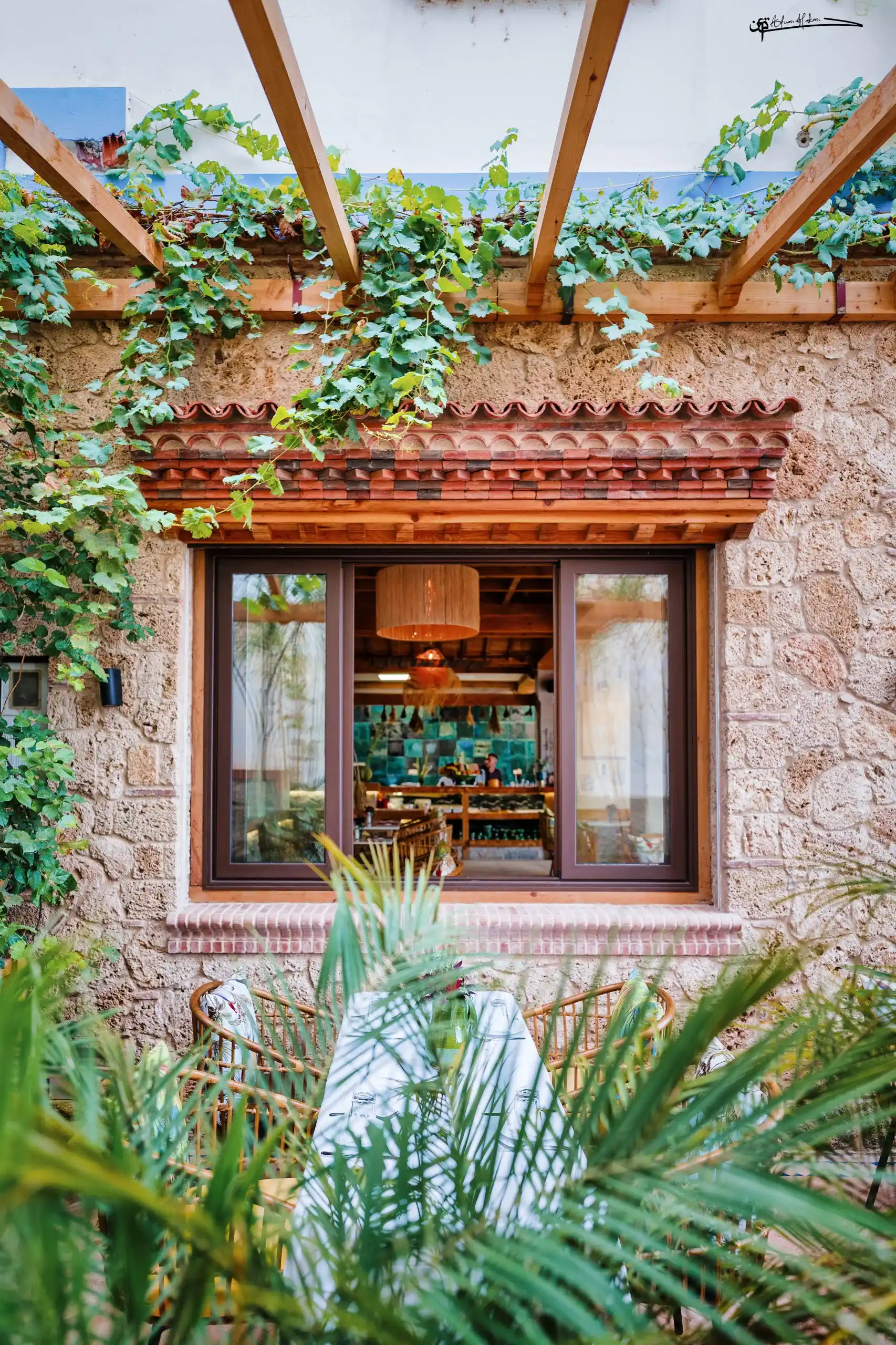 Rooftop terrace seating at Triana with evening light in Chefchaouen