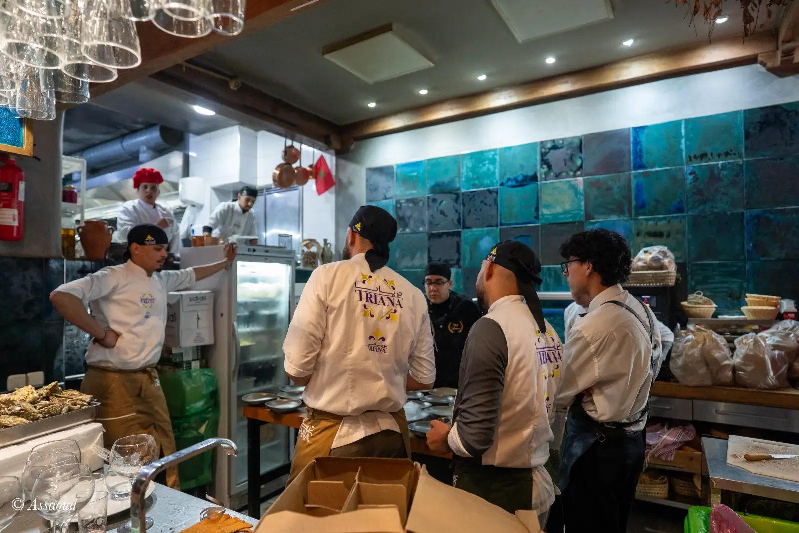 Triana restaurant team gathered in the open kitchen on New Year's Eve, wearing Triana branded jackets